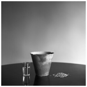 Rahgozar - photograph: a clay pot, a glass of water and grains
