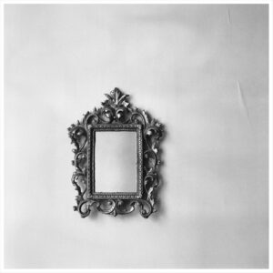 Rahgozar - photograph: an ornate empty mirror frame on a wall